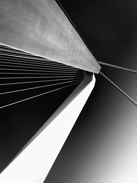 a close up of an angled structure with a long line of wires coming down it