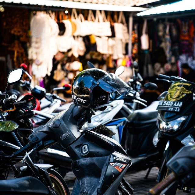 some parked motorcycles are outside of a building