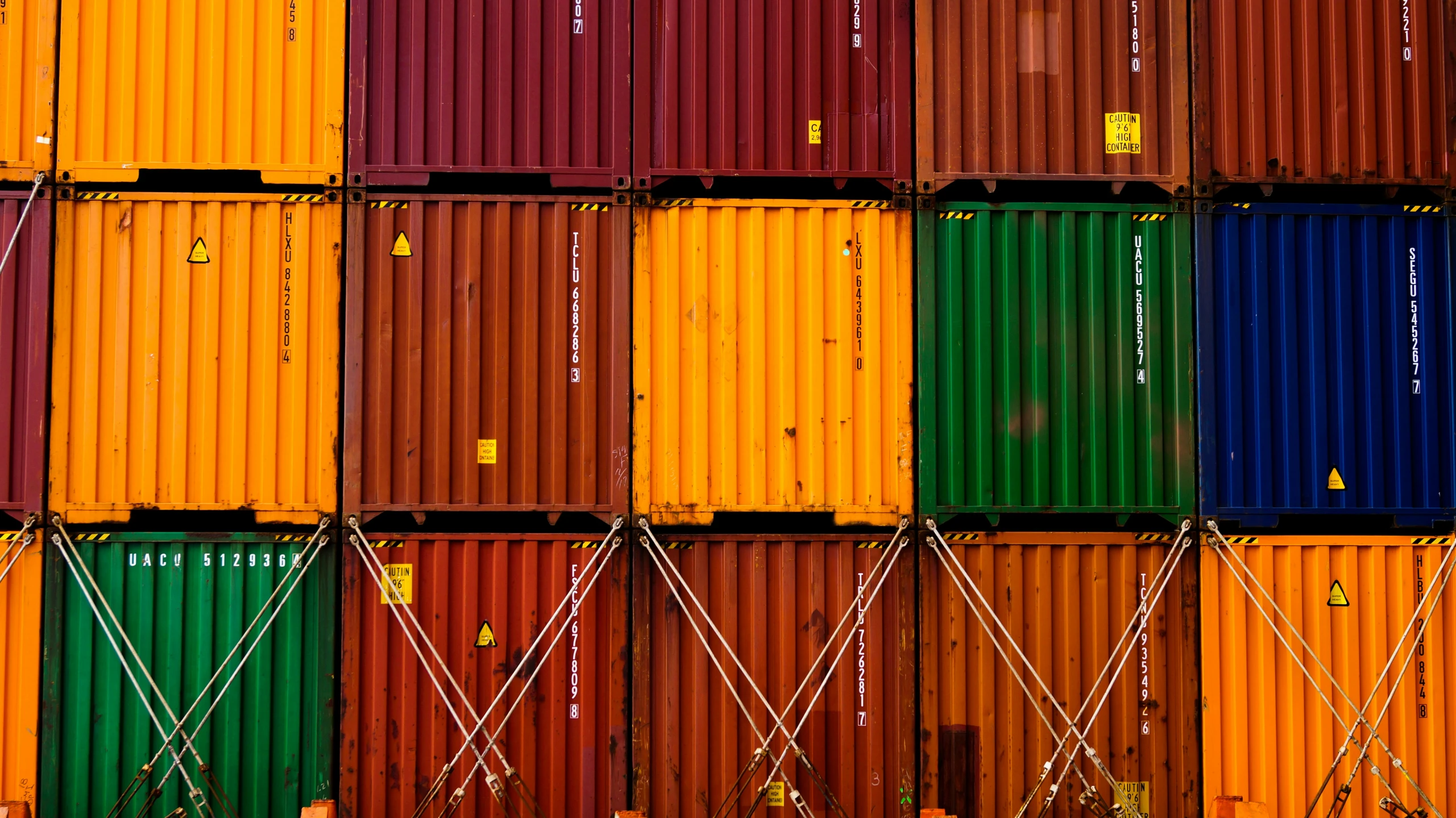 many colored cargo containers stacked together