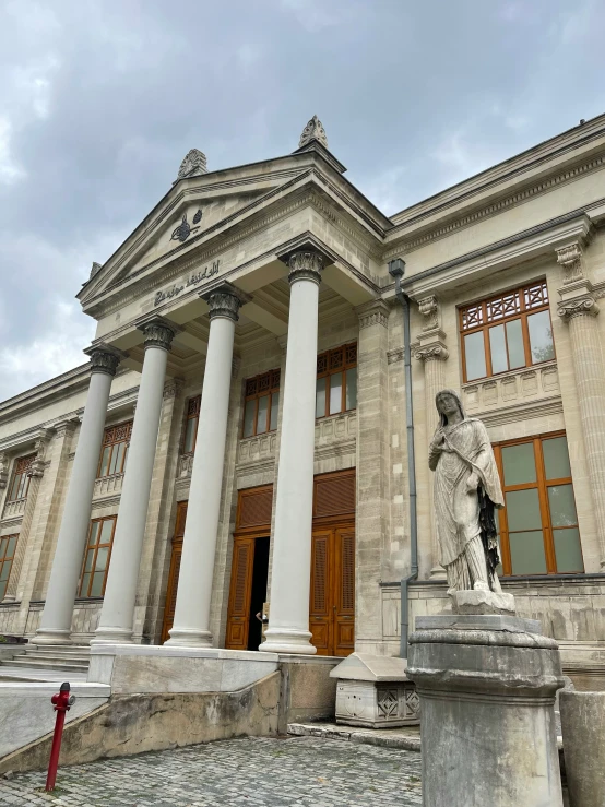 a tall and ornate building with three columns