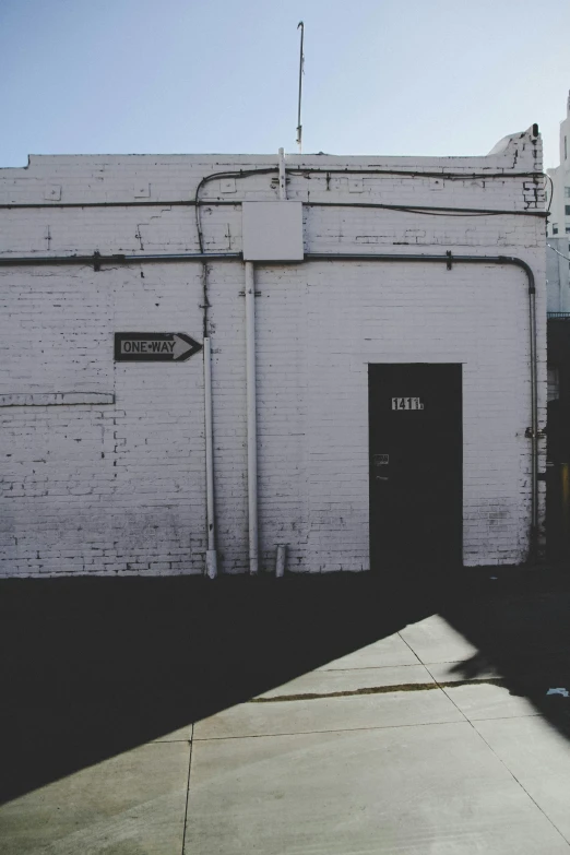 a white brick building with a black and silver door