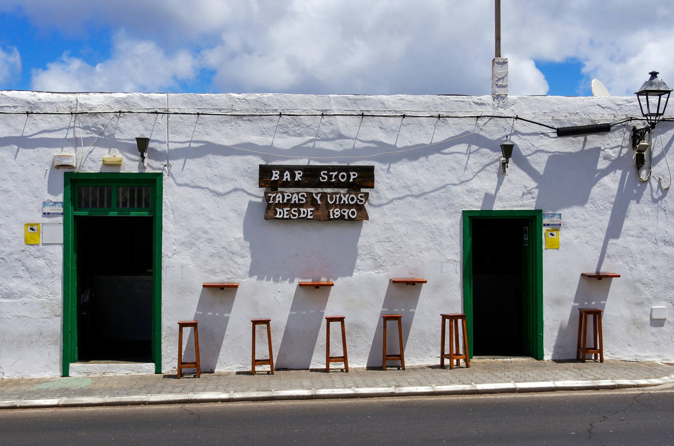 the building is painted a white color with a green door