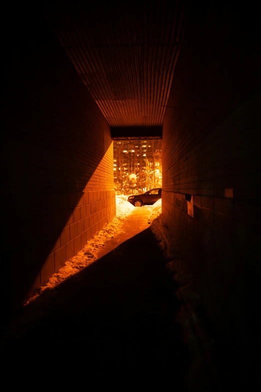 a tunnel under the street with lights coming in from it