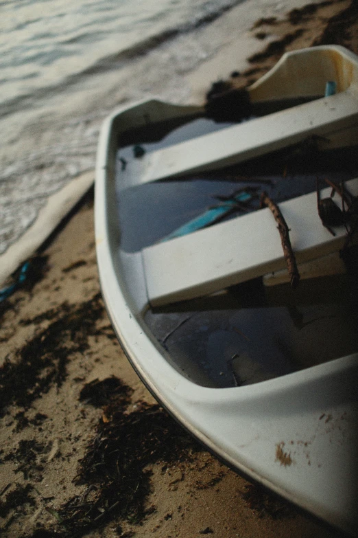 a boat sitting on top of a beach next to the ocean