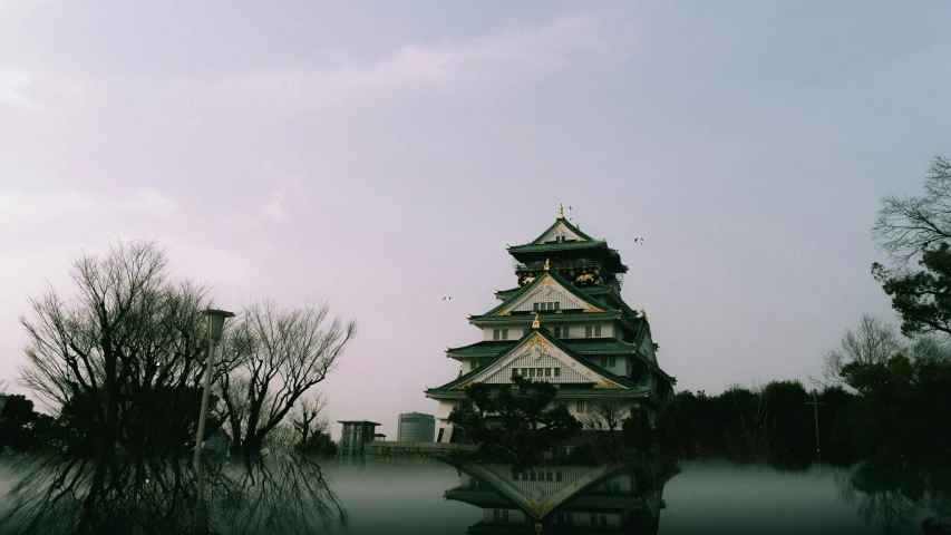 a white and black clock tower towering above trees