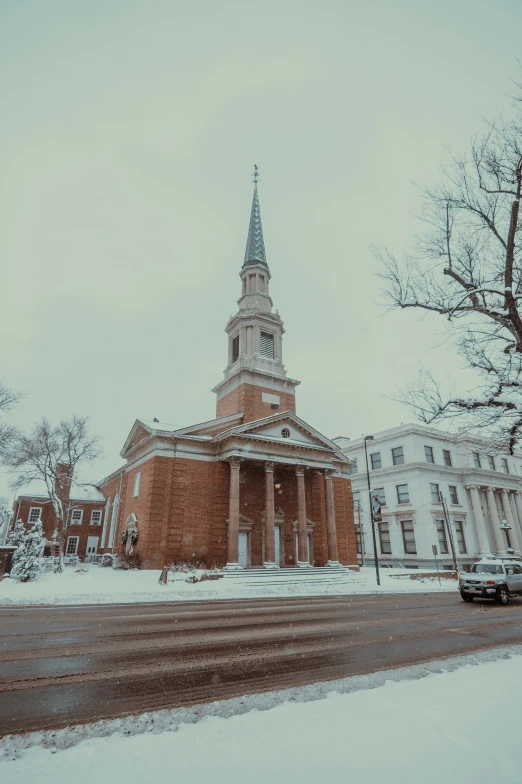 a red brick building with two steeples on top and a clock