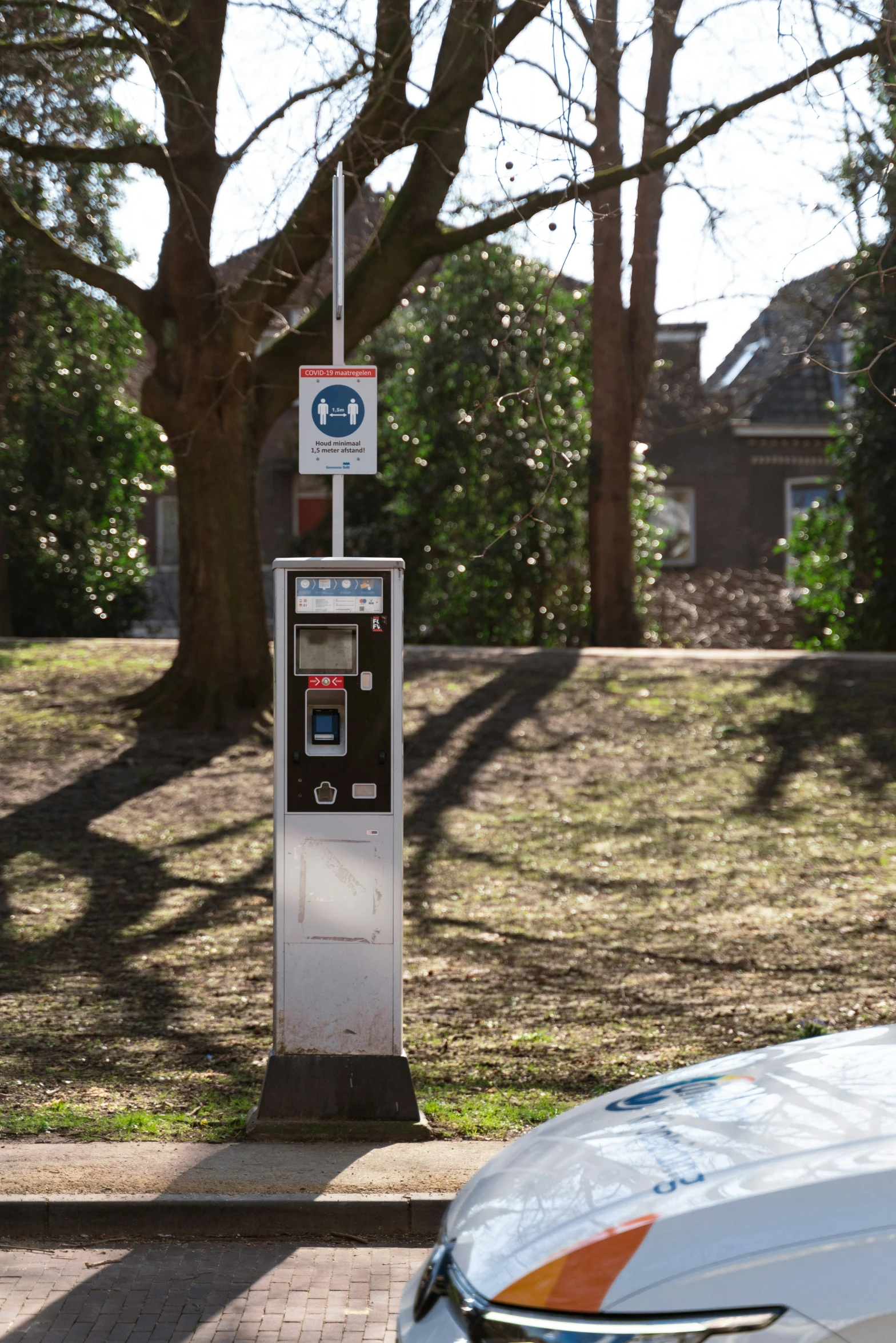 the parking meter has a sign posted to it