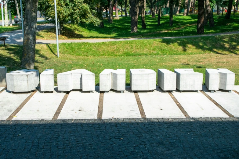 a row of cement blocks sitting in front of a park