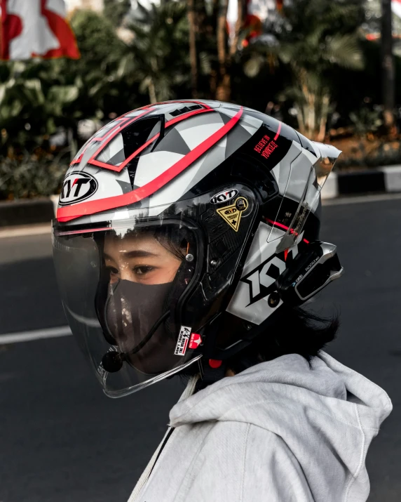 a man in a motorcycle helmet is on the street