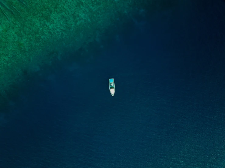 a single boat in the middle of the ocean