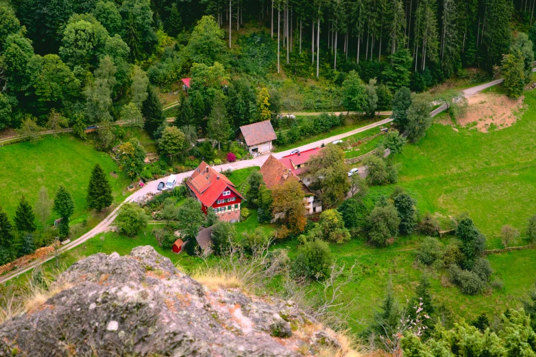 a scenic area showing an old house, farm and roads