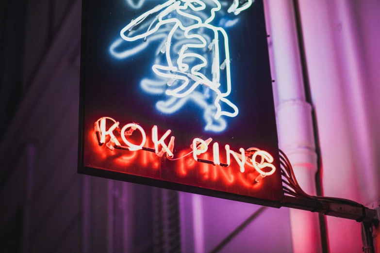 a neon sign that says row plying with someone doing soing