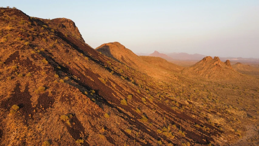 a mountain ridge surrounded by scrub brush