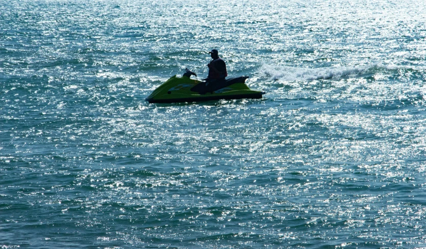 a person riding a small boat out in the ocean