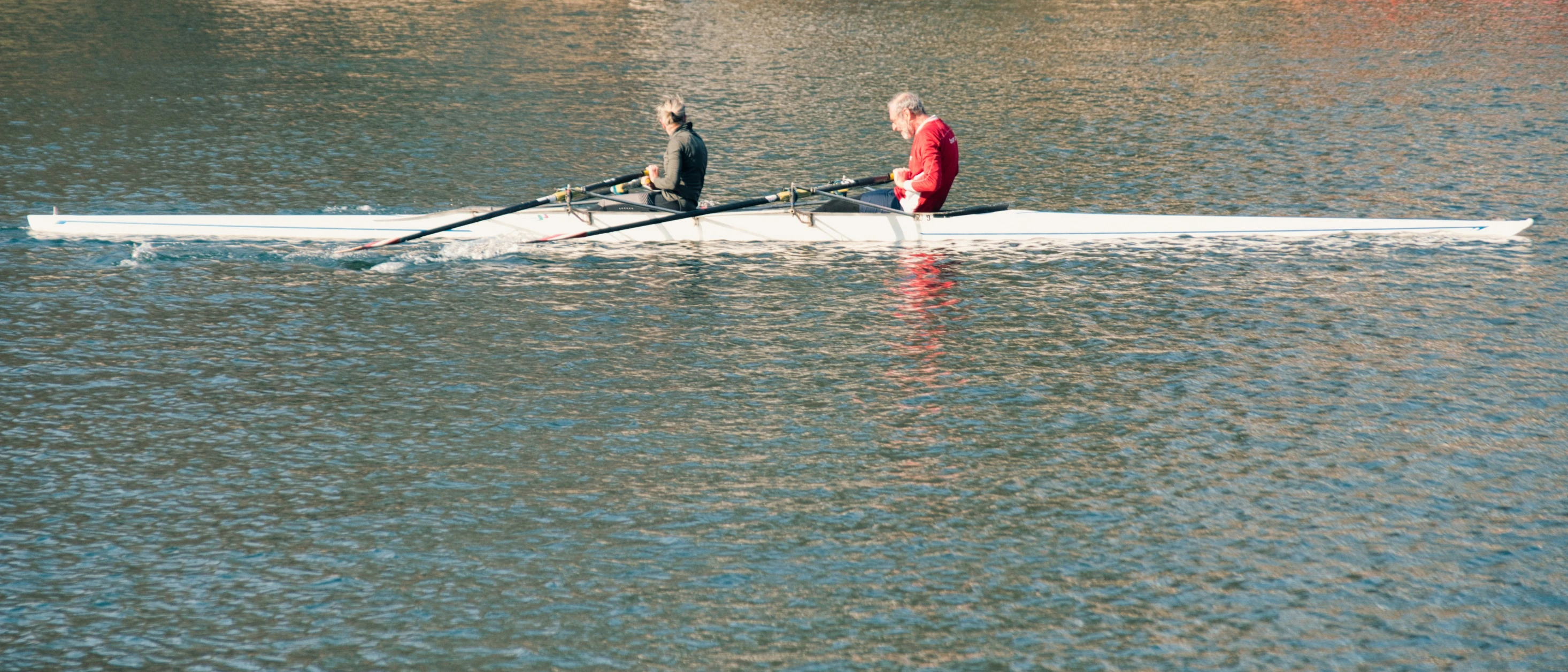 there is a person on the rower boat rowing down the water