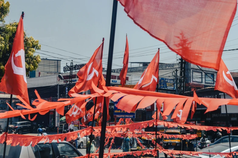 orange flags in the wind on a city street