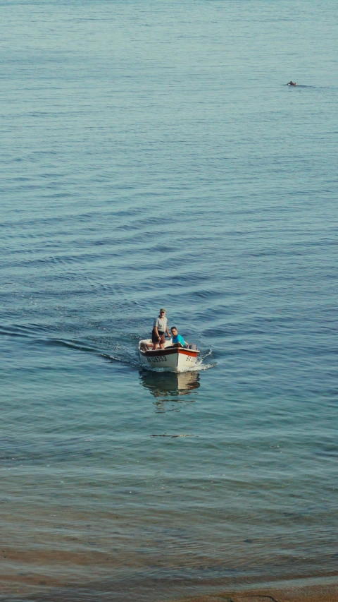 people in a small boat are out on the water