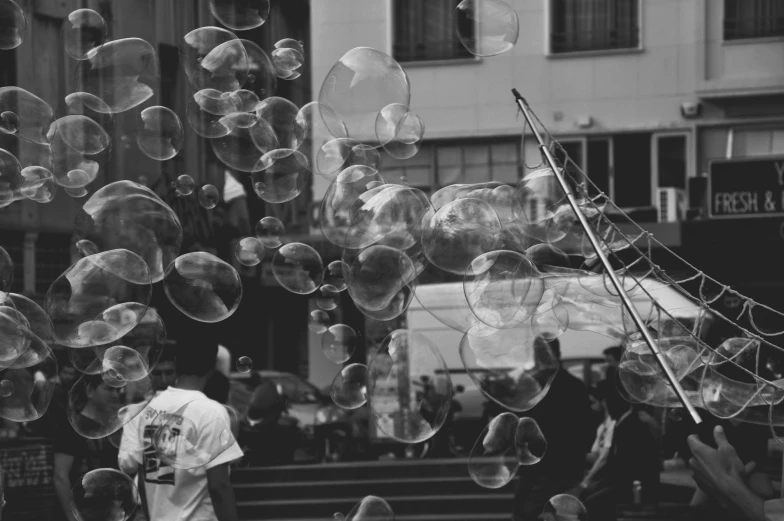 several balloons are flying through the air with buildings in the background