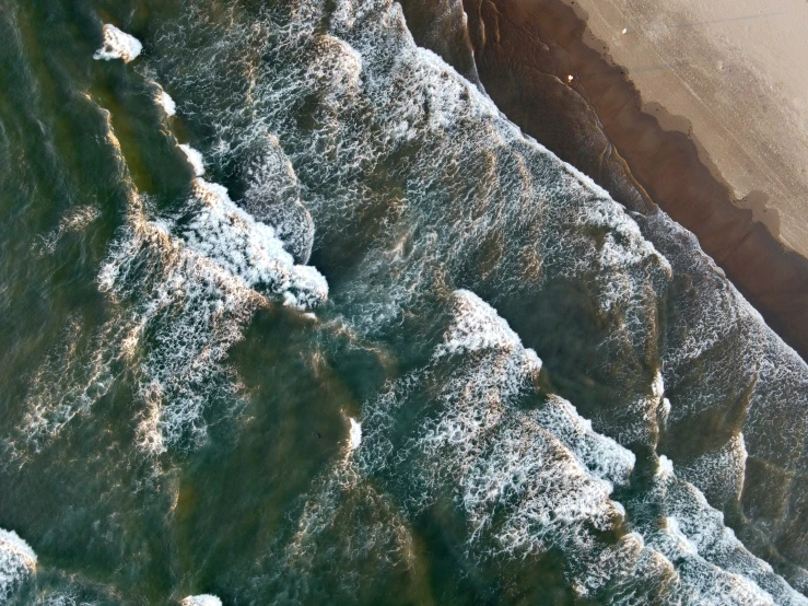 a group of ice covered hillside next to a beach