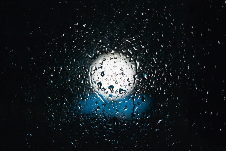 the view from inside the window of an outside structure at night