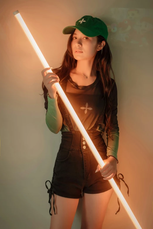 woman holding a large light saber while wearing dark clothing