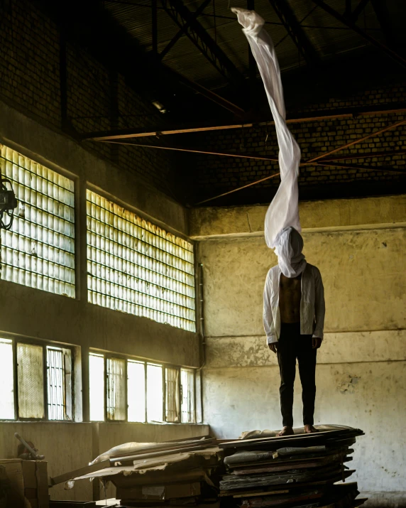 a man stands on a stack of papers