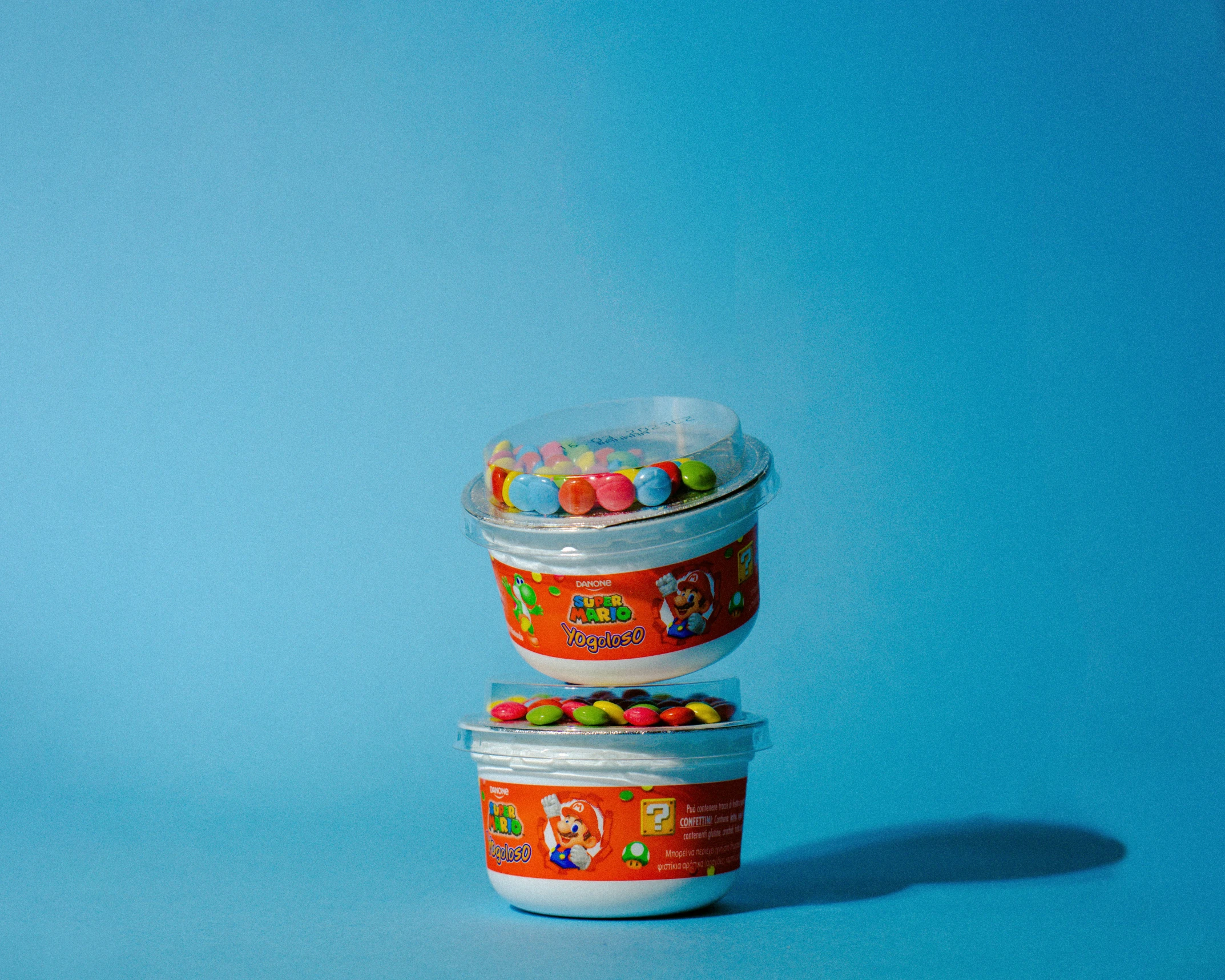 three tins of candies are stacked up against each other