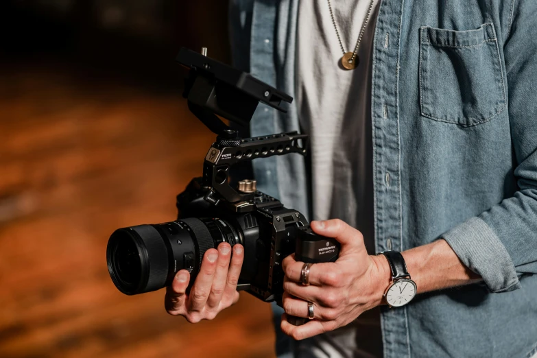 a person holding a camera and a lens