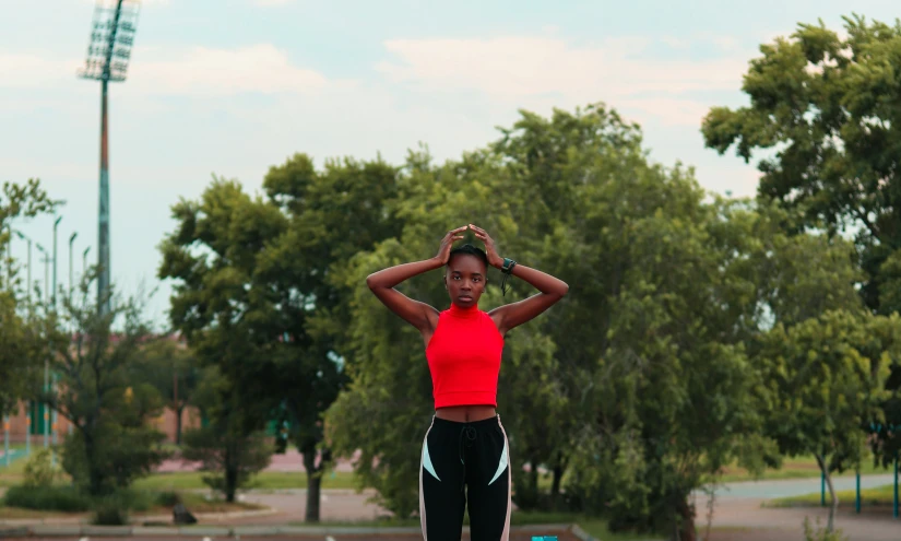 a young woman with headphones stands on a skateboard