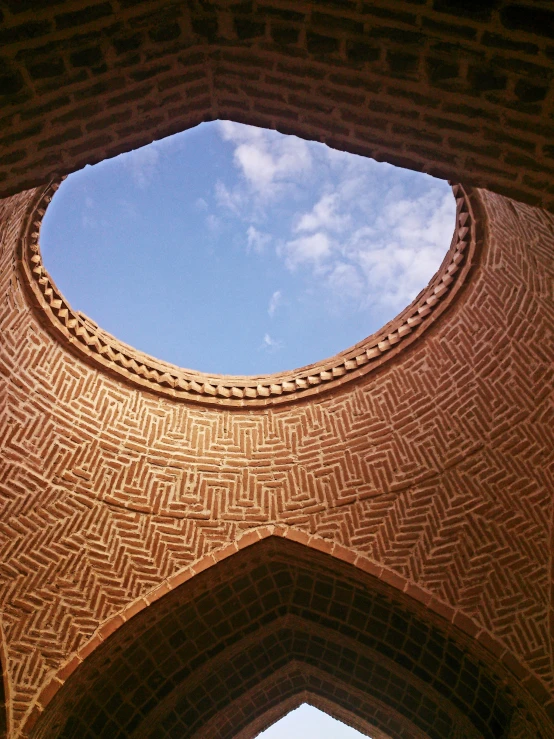 a circular window above the inside of a brick building