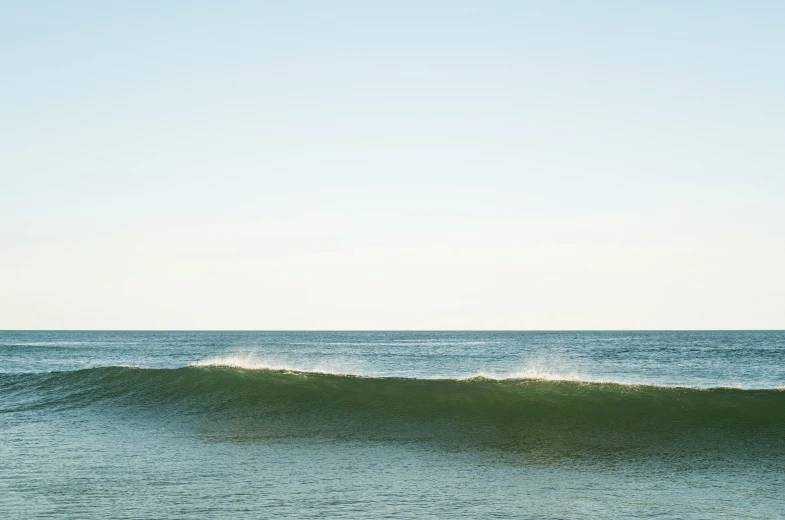 a man standing on his surfboard on the ocean