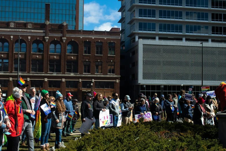 an outside view of a group of people gathered together for a protest