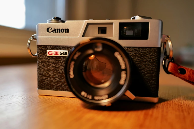 a black and silver camera on a table