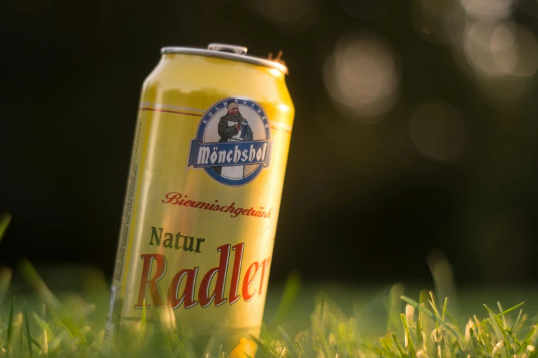 a can of beer in the grass outside