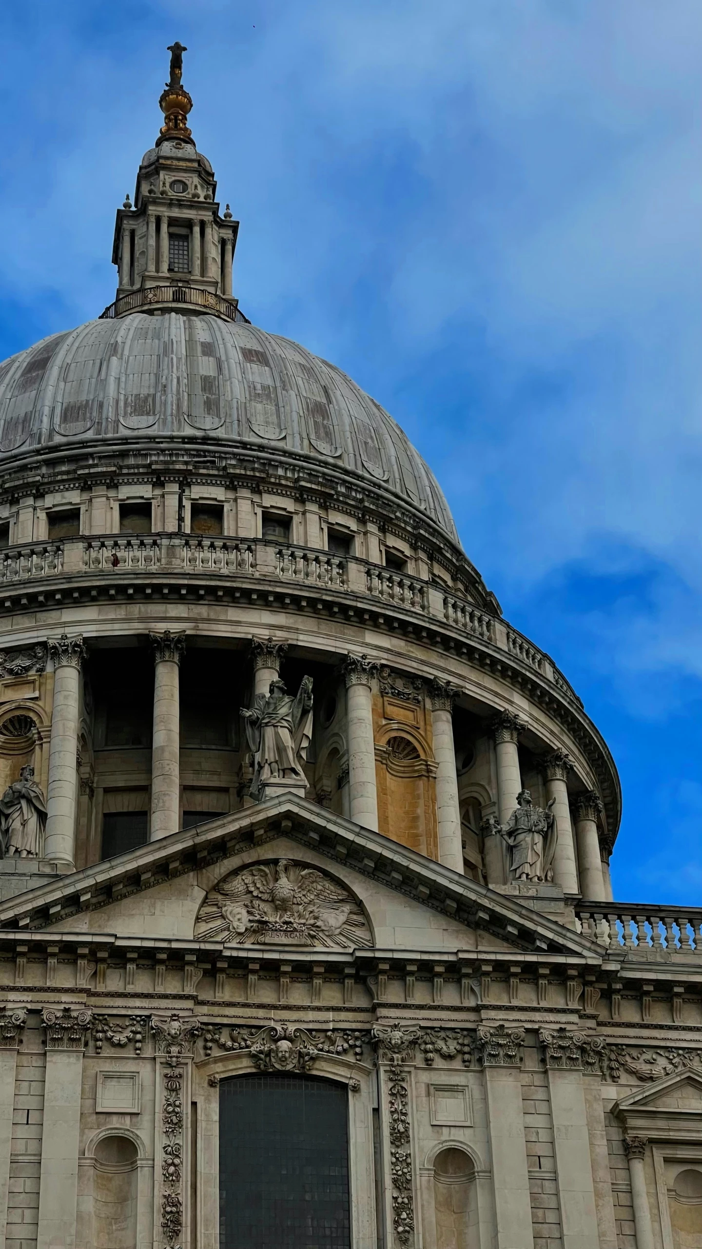 a large building with a dome and statues