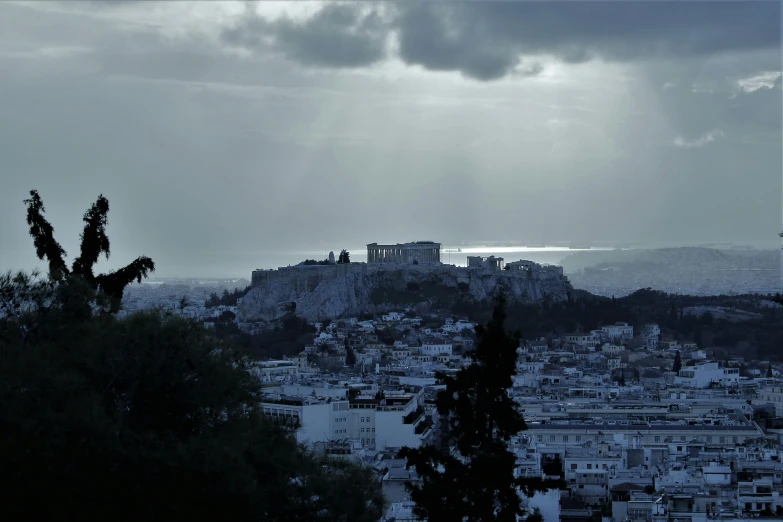 a cityscape with a castle on top in the background