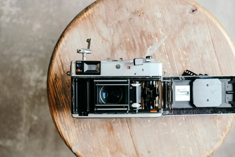 an old fashioned camera sitting on top of a wooden table