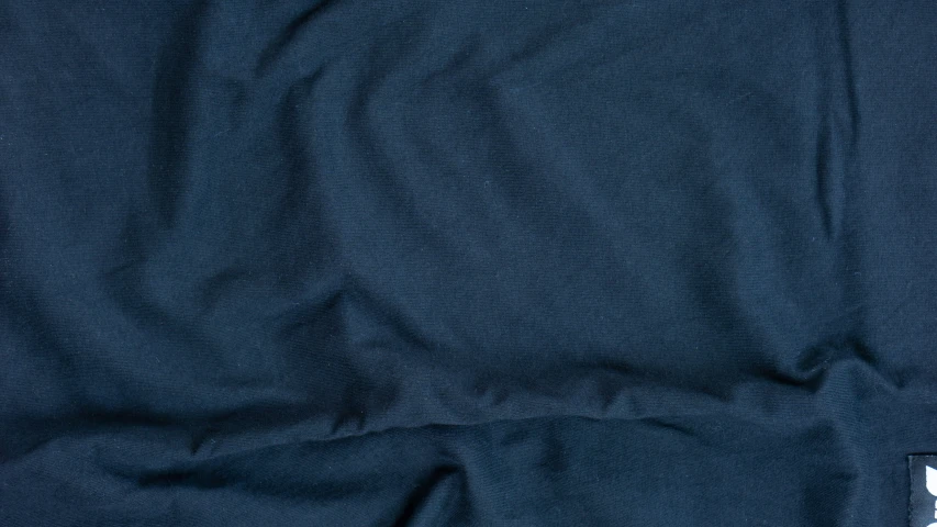 the back of a blue shirt with a white stripe on it