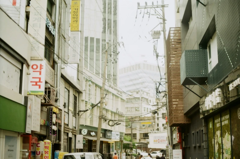 a street that is full of buildings on a rainy day