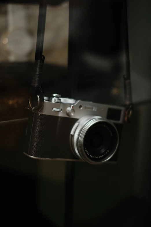 a small silver camera sitting on top of a table