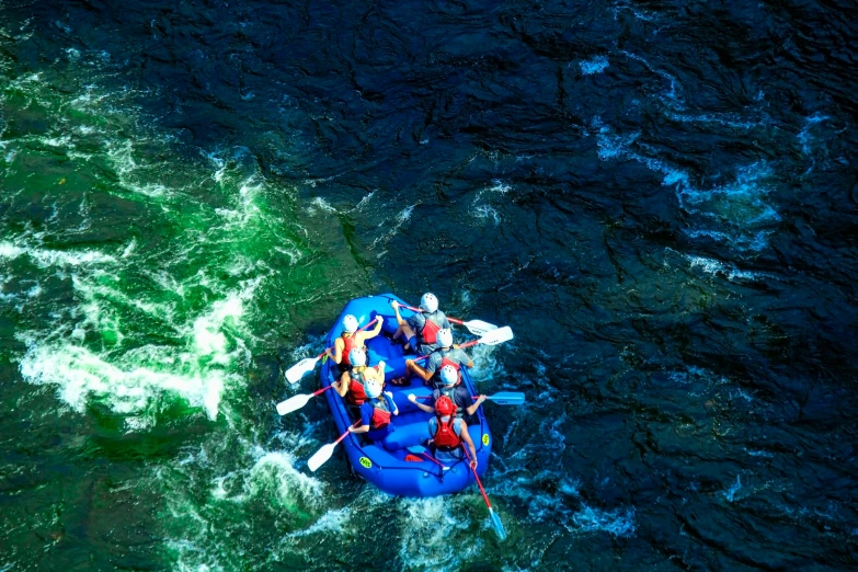 two people in a raft on a body of water