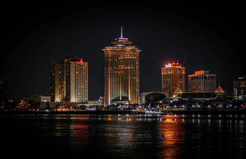 some large buildings and some water at night