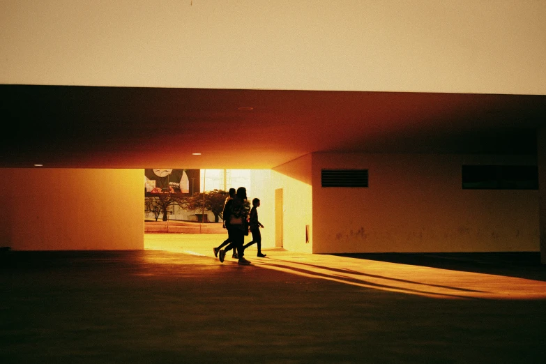 two people walking into the light in a hallway