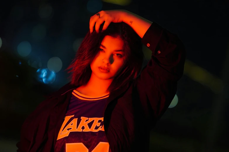 a woman with long hair and a lit shirt is posing