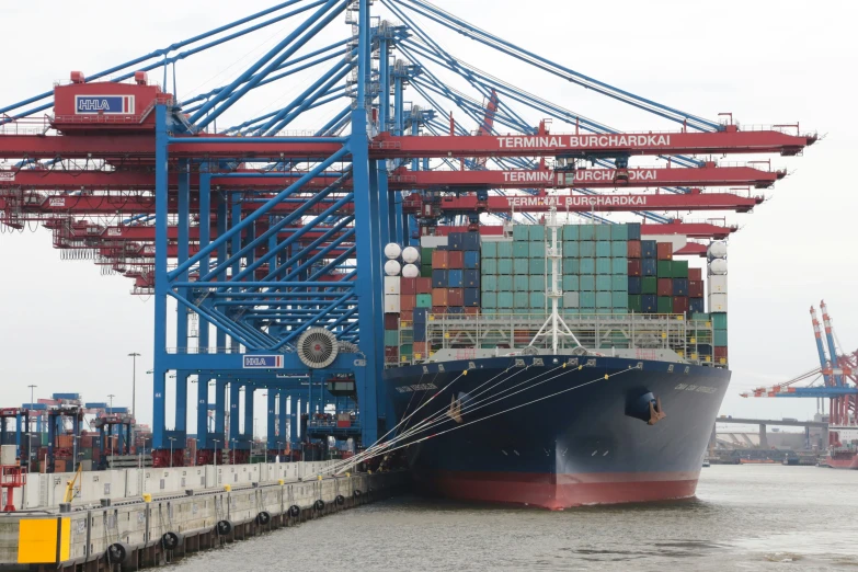 the large blue and red container ship is moored