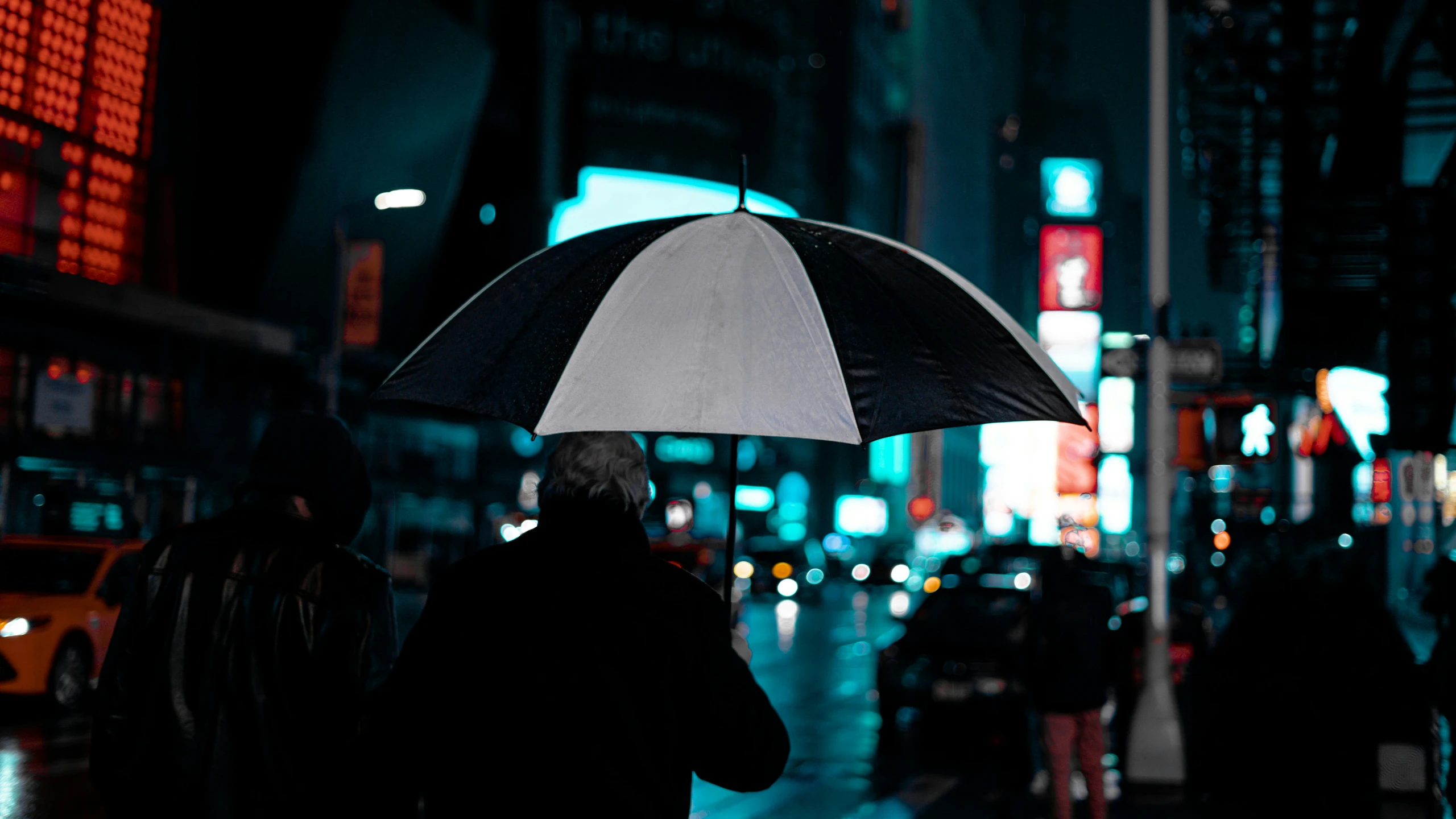 a man with an umbrella walks down the street