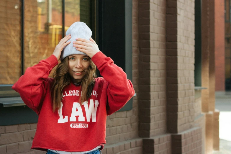 a young woman covering her ears while walking