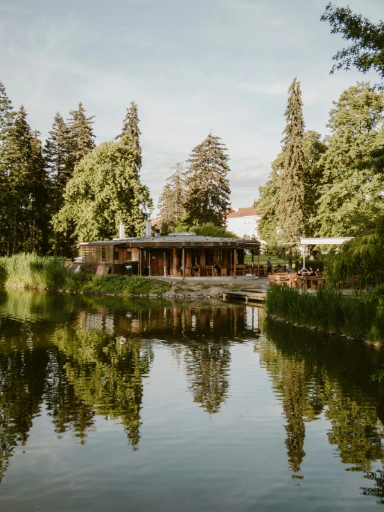 the boat house is on the lake by the trees