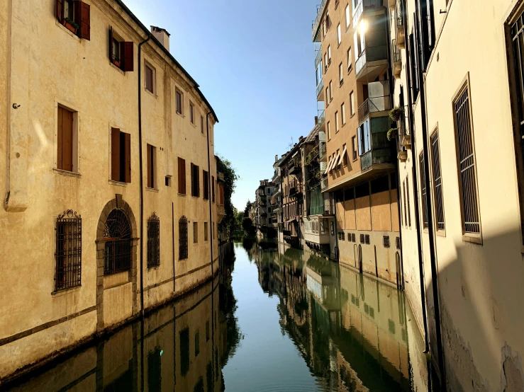 the buildings line the water with one boat