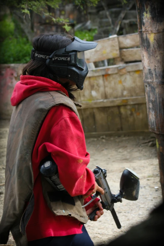 the person has a motorcycle helmet on and it is holding an object